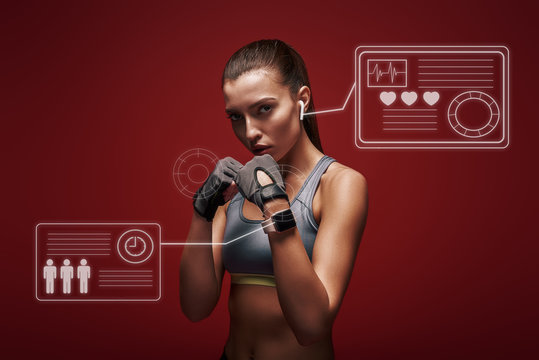 Modern athlete. Sportswoman standing concentrated in gym gloves over red background. Game concept with graphic drawing.