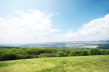 Landscape of green meadow on the mountain with blue sky and clond