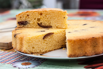 home made sponge cake round with plum and dates