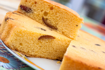 home made sponge cake round with plum and dates