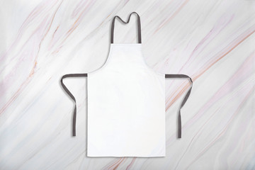 Mockup of white apron on marble background. Branding or identity template