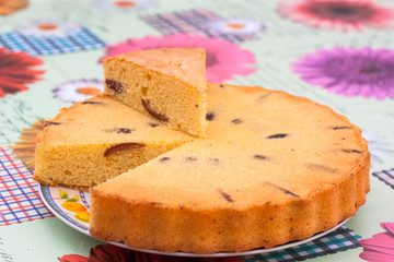 home made sponge cake round with plum and dates