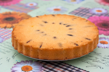 home made sponge cake round with plum and dates