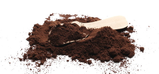 Milled coffee powder with wooden spoon isolated on white background