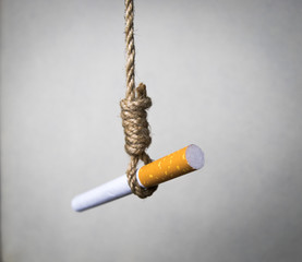 Cigarette hangs on a hangmans knot. stop smoking. smoking kills.