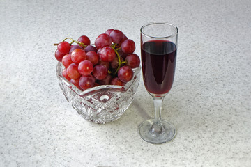 Still life vase with grapes and a glass of wine