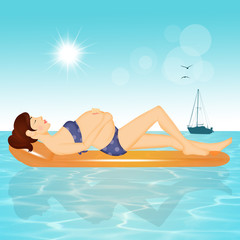 pregnant woman on a beach mattress