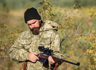 Man hunter with rifle gun. Boot camp. Bearded man hunter. Army forces. Camouflage. Military uniform...