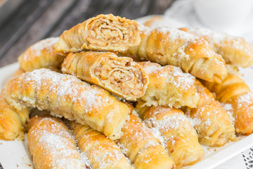 Baked sugar food dessert on wooden plate. Cookies and pastry