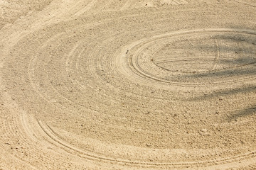 Fototapeta na wymiar close up background of the rough sand field texture with many circle lines in the golf course