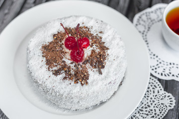 Bakery delicious food concept. Big tasty cake with nuts and cherry inside with cream 