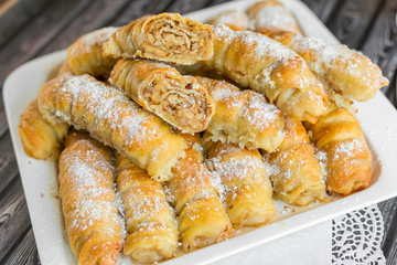 Baked sugar food dessert on wooden plate. Cookies and pastry