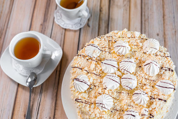 Cake delicious on plate. Bakery, cream dessert cake with tea spot on wooden table