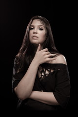 portrait of young brunette girl with black tears from eyes and lace pattern on face and neck posing...
