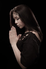 portrait of young brunette girl with black tears from eyes and lace pattern on face and neck posing...