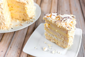 Cake delicious on plate. Bakery, cream dessert cake with tea spot on wooden table