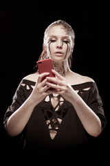 young brunette girl with black tears from her eyes makes selfie, talks and writes by phone