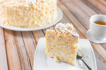 Cake delicious on plate. Bakery, cream dessert cake with tea spot on wooden table