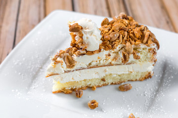 Cake delicious on plate. Bakery, cream dessert cake with tea spot on wooden table