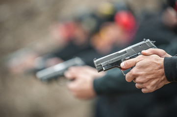 Close-up view of shooter practice handgun shooting in row group