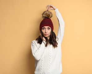 Funny woman touching pompom on hat