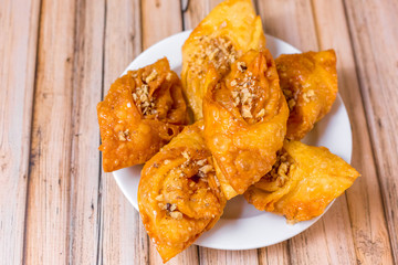Baked sugar food dessert on wooden plate. Cookies and pastry