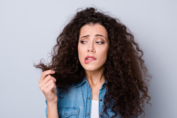 Close-up portrait of her she nice attractive worried nervous wavy-haired girl holding looking at dry wealth curls thinking about solution repair anti loss isolated over gray pastel background