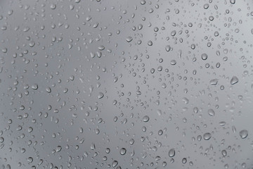 glass and rain drops, raindrops on glass, a nice way raindrops on glass, moving raindrops on the balcony railing,