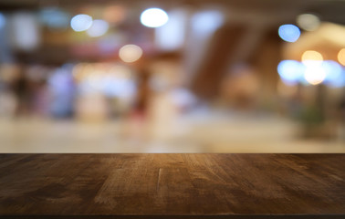 Empty dark wooden table in front of abstract blurred bokeh background of restaurant . can be used for display or montage your products.Mock up for space.