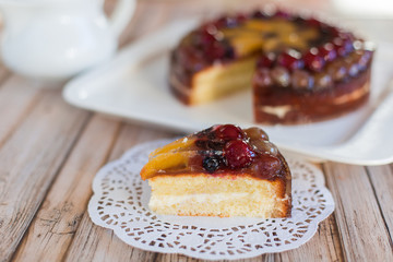 Cherry delicious tasty baked pie with fresh fruits on white plate