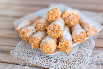 Delicicous cookies with nuts and cream on plate