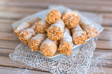 Delicicous cookies with nuts and cream on plate