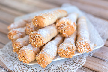 Delicicous cookies with nuts and cream on plate