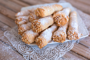 Delicicous cookies with nuts and cream on plate