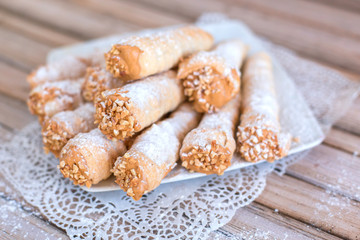 Delicicous cookies with nuts and cream on plate