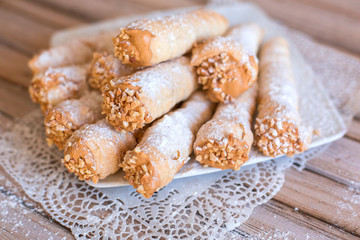Delicicous cookies with nuts and cream on plate