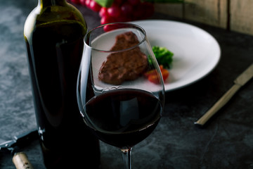 Closeup of Red Wine and Steak Dinner 