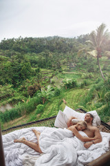 Honeymoon at Bali, Ubud. Successful couple relaxing at villa, beautiful view