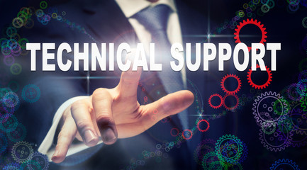 A businessman pressing a Technical Support business concept on a graphical display of cogs