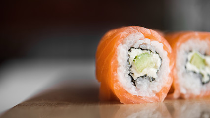 Closeup of sushi rolls with philadelphia cheese and avocado