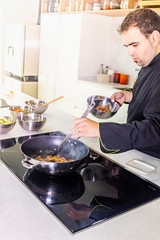Chef frying chicken to make a wok