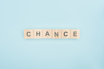 top view of chance lettering made of wooden blocks on blue background