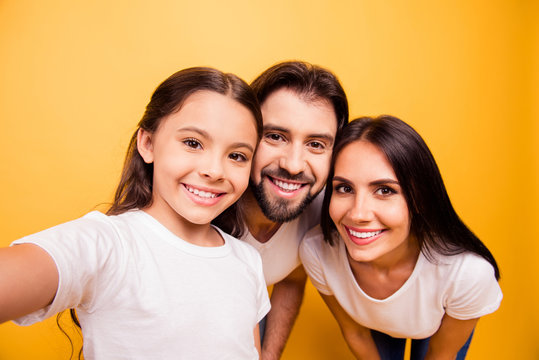 Self-portrait of nice cute lovely adorable attractive charming cheerful people mommy daddy pre-teen girl having fun day isolated over shine vivid pastel yellow background