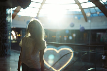 Beautiful blond girl posing at the mall