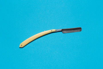 old vintage razor on blue background