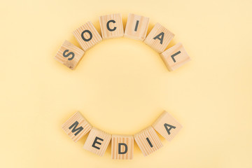 top view of social media phrase made of wooden blocks on yellow background