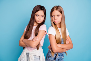 Portrait of two people nice cute lovely attractive sad mad offended gloomy straight-haired pre-teen...