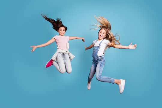 Full length body size view of two people nice lovely attractive cheerful straight-haired pre-teen girls having fun day daydream yes goal achievement free time isolated on blue background
