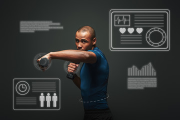 Everything is possible. Dark skinned sportsman working out with dumbbells over dark background....