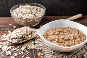 Rye porridge on dark wooden background.